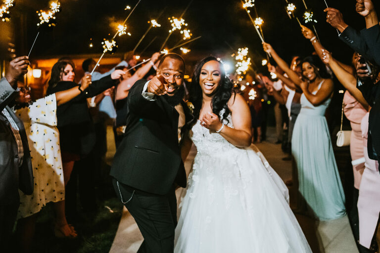 bride and groom cheer during their sparkler exit