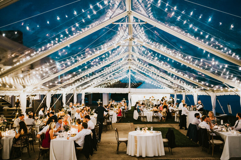 a nighttime wedding reception under a magical tent